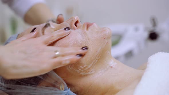 A Woman Receives Professional Facial Treatments