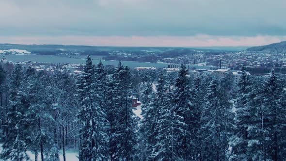 Moving aerial scene revealing Östersund city in Sweden on winter day