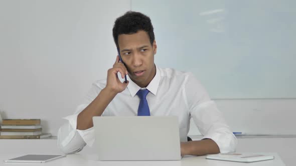 AfroAmerican Businessman Yelling in Anger During Phone Talk Negotiating