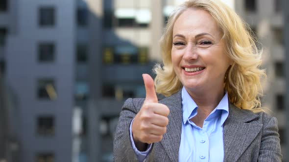 Aged Female Employee Showing Thumbs Up, Benefits of Hiring Old Workers, Closeup