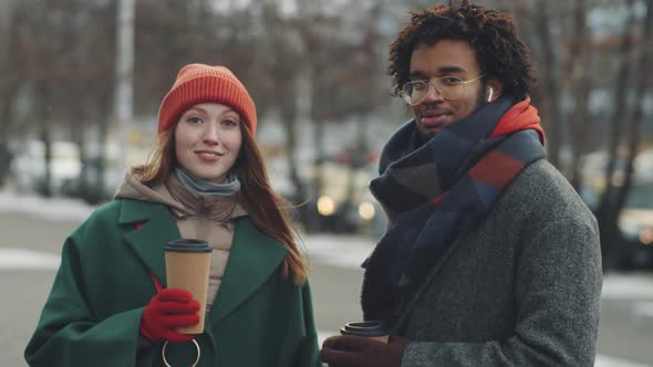 Portrait of Diverse Man and Woman with Coffee Cups Outdoors