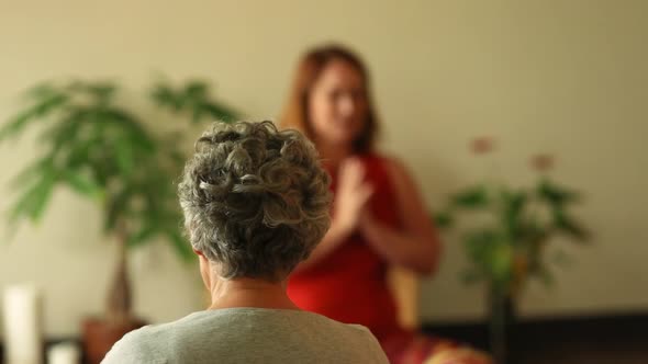 Woman with Instructor Praying Before Yoga