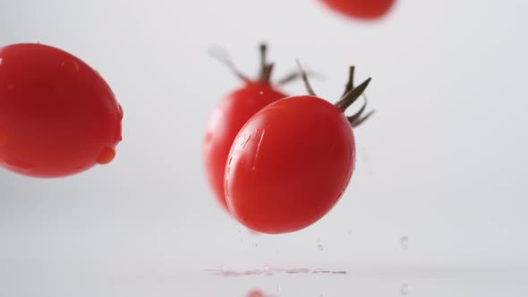 Cherry tomatos falling. Slow Motion.