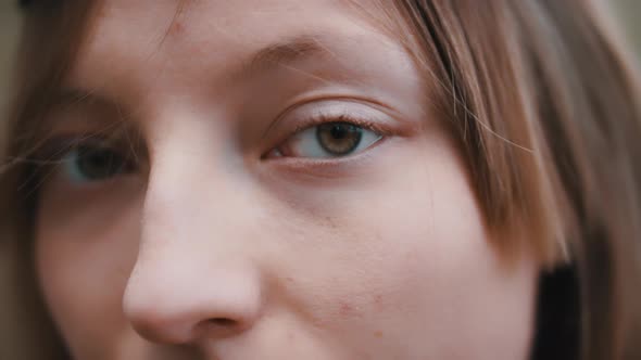 Extreme Close Up Shot of the Woman with No Make Up in the Nature. Girl Lifting Up Her Head. Natural