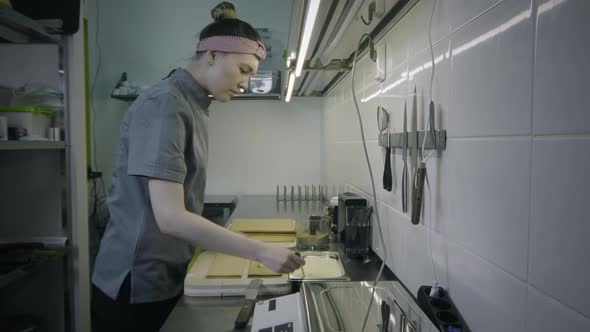 Confectioner female preparing a cake