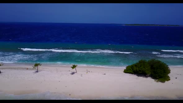 Aerial drone seascape of idyllic seashore beach voyage by blue lagoon and bright sand background of 