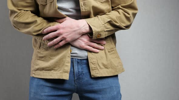 Man Suffers From Severe Pain in Stomach Touching Belly