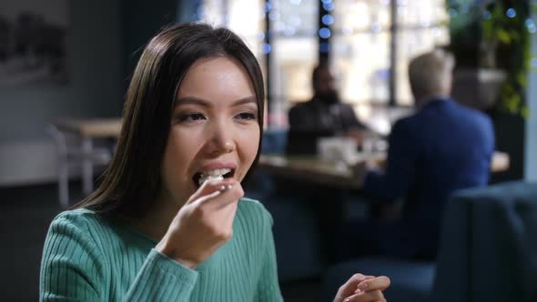 Close Up Charming Asian Woman Eating in Restaurant