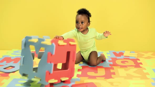 Baby boy playing with toy alphabet letters