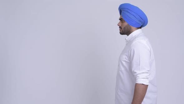 Profile View of Happy Young Bearded Indian Sikh Man Smiling