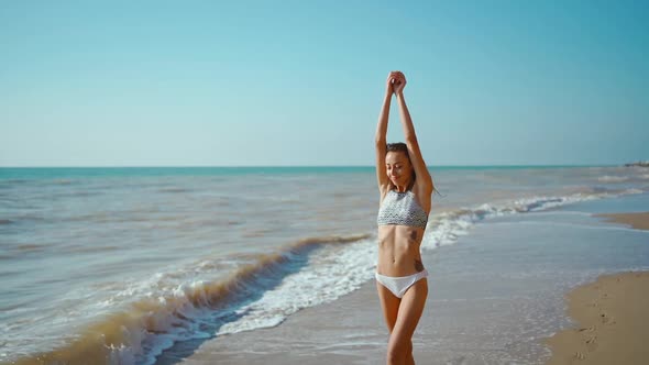 Slow Motion of Happy Joyful Slim Fitbody Woman Wearing in Bikini and Enjoying Wind and Waves on Sea