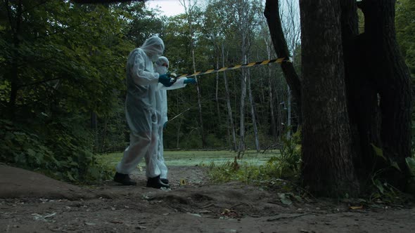 People Wearing Ppe White Suits Protecting Territory with Signal Tape