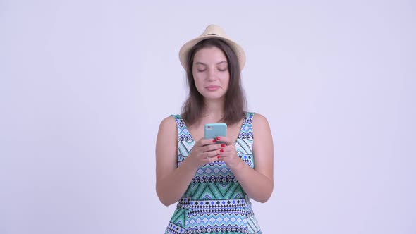 Happy Young Beautiful Tourist Woman Thinking While Using Phone