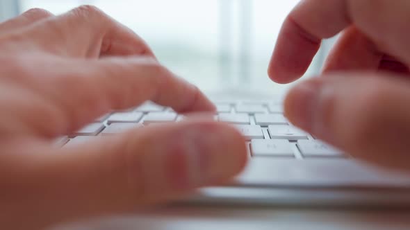 Male Hands Typing on a Computer Keyboard Extreme Closeup