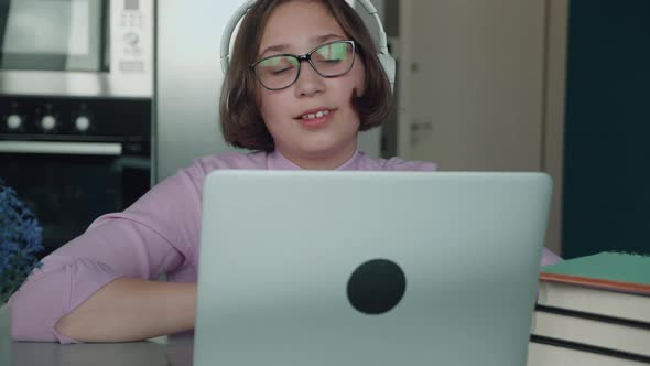 Schoolgirl Girl Studies Online On Laptop At Home