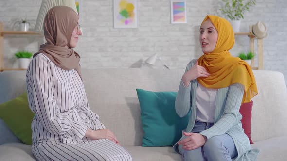 Portrait Two Smiling Beautiful Deaf Young Muslim Women in Hijabs Talking With Sign Language in the