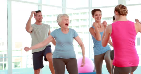 Aerobics Class Stepping and Laughing Together