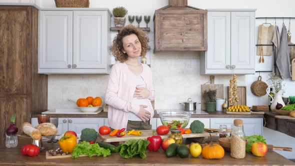 Happy Pregnant Woman On Kitchen