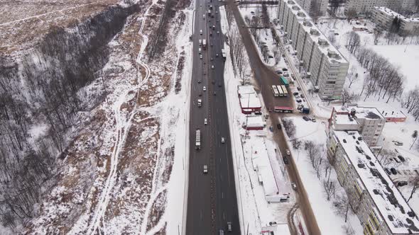 Suburban Highway with Cars and Multistorey Buildings in Winter Aerial View