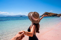 Young couple tourism enjoying the tropical pink sandy beach at Komodo islands in Indonesia - PhotoDune Item for Sale
