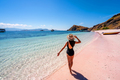 Young female tourism enjoying the tropical pink sandy beach at Komodo islands in Indonesia - PhotoDune Item for Sale
