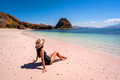 Young female tourism enjoying the tropical pink sandy beach at Komodo islands in Indonesia - PhotoDune Item for Sale