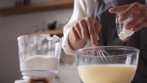 Woman's Hands In Home Kitchen With Mixer, Glass Bowl, Scale With Flour, Bowl With Baking Powder