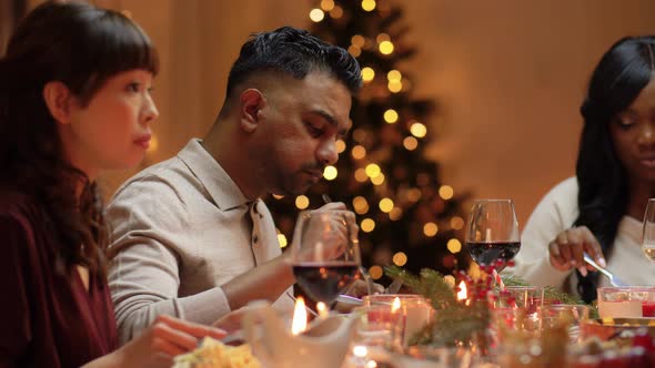 Happy Friends Having Christmas Dinner at Home