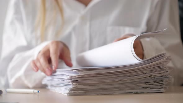 Sign documents concept. Businesswoman in shirt sitting in her workplace in office