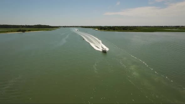 Flying over boats in the IntraCoastal Waterway during middle of the day in the summer on a sunny day