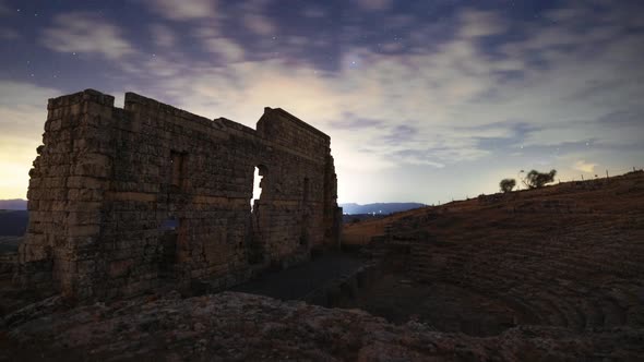 Majestic ruins of ancient theater at sunset