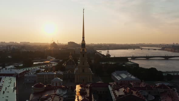 The Drone Flies to the Golden Angel on the Cross of the Peter and Paul Fortress at Sunrise