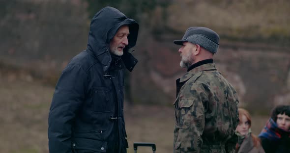 Angry Military Man Arguing With Senior Male Refugee