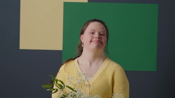 Portrait of Happy Girl with Down Syndrome Holding Flower Bouquet