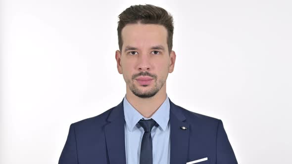 Portrait of Young Businessman Looking at the Camera, White Background