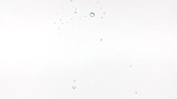 Slow Motion of Falling Lemon Slices in Water and Air Bubbles on White Background