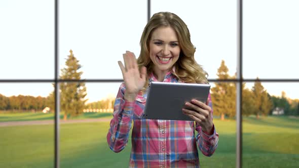 Young Happy Woman Having Video Chat on Tablet Pc.