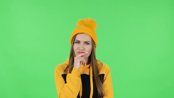 Portrait of Modern Girl in Yellow Hat Is Thinking About Something, and Then an Idea Coming To Her