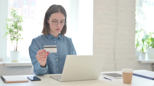 Successful Online Payment on Laptop by Young Woman