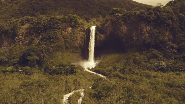 Zooming in on a large and stunning waterfall with a warm filter