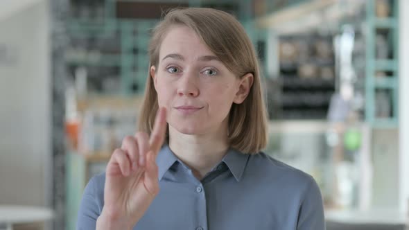 Portrait of Young Woman Showing No Sign By Finger