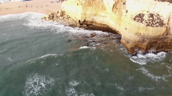 Carvoeiro Beach Resort Town in Algarve, Portugal - Tilt up Reveal Aerial shot