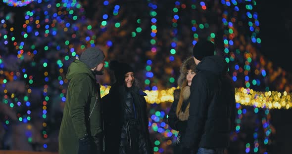 Cheerful Company of Friends Is Talking in the Park in Winter