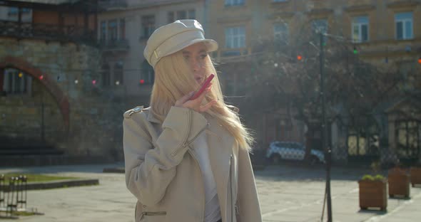 Woman Using a Smartphone Voice Recording Function Online in the City Street, Talking To Mobile