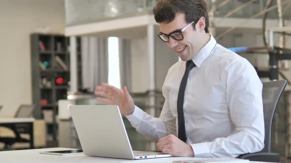 Businessman Working on Laptop in Office