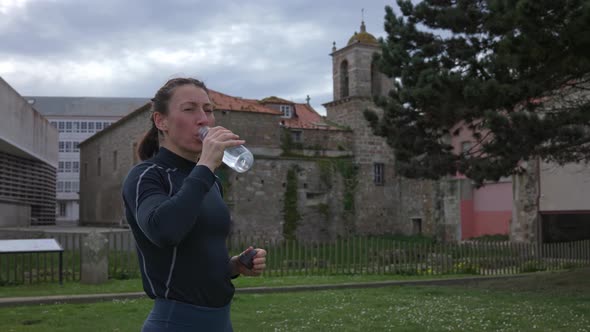 The Girl Drinks Water and Closes the Water Bottle