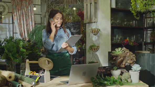 Florist Answering Phone Call in Flower Store