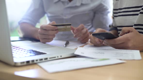 Man and woman paying bills at home