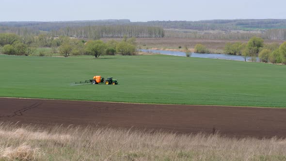 Sowing, Processing of Fields. Pest Control. Trailer Sprayer in Operation.