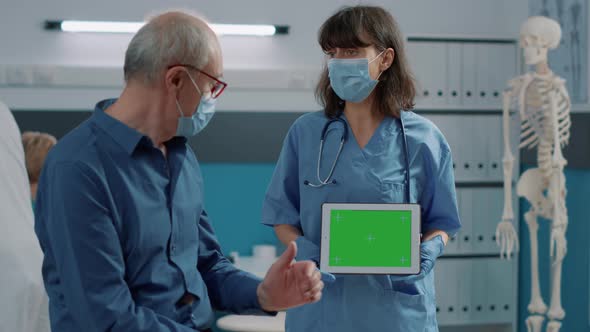 Medical Nurse Holding Horizontal Green Screen on Digital Device